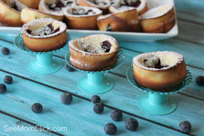 My family gobbled up these blueberry dutch baby pancake which I made in a muffin tin for easy serving, in a snap. They're delicious and SO easy! A perfect breakfast recipe or easy brunch recipe.