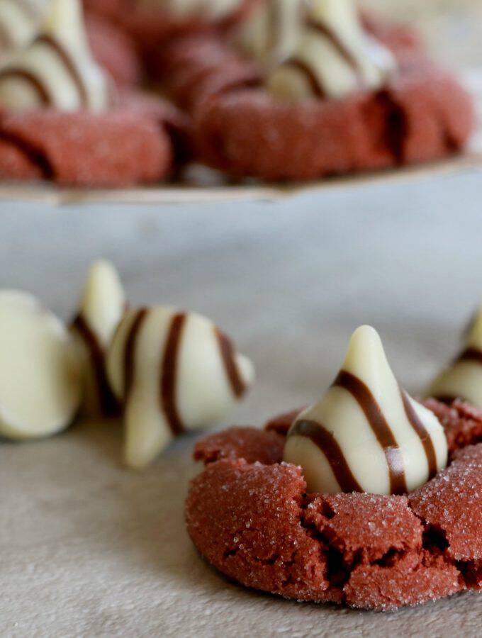 Here's a fun twist in a classic! These Red Velvet Peanut Butter Blossoms Recipe are perfect for a Valentine's Day dessert or class party treat.